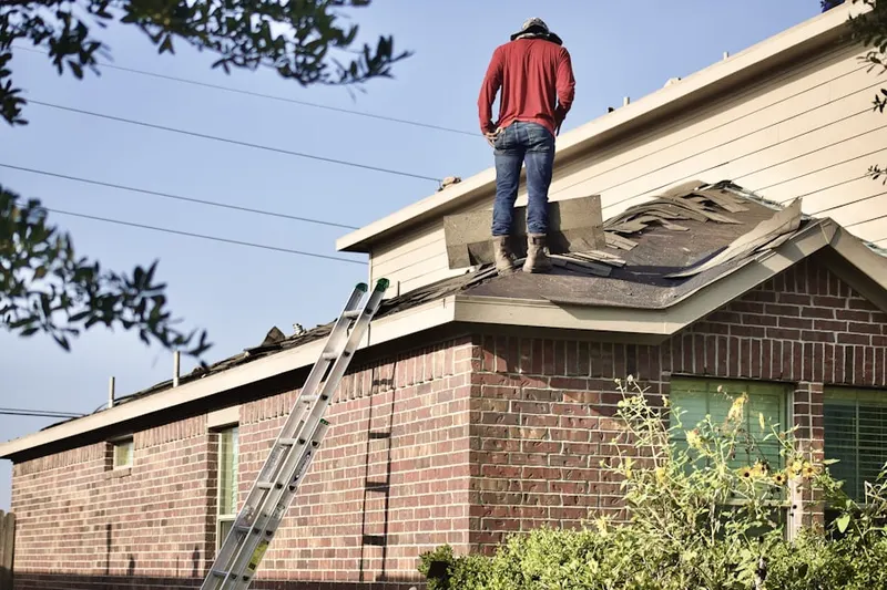Professional roofer working on a residential roof in Pineton